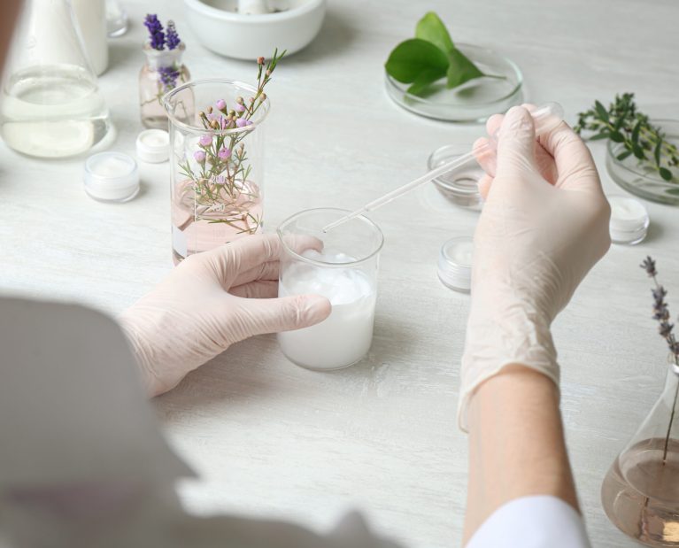 Scientist developing cosmetic product in laboratory, closeup